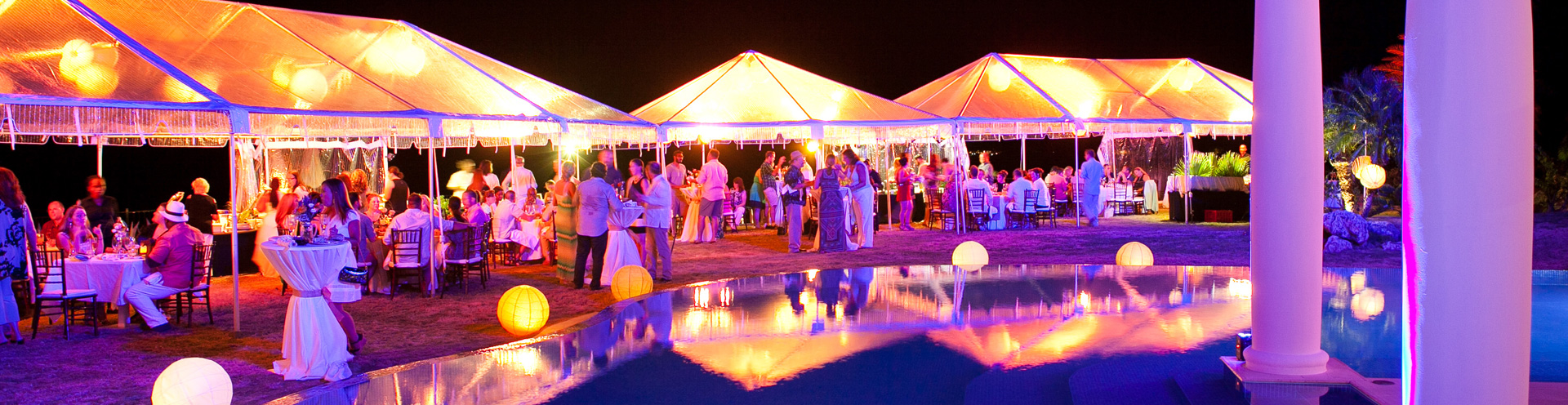 Outdoor event with clear tent glowing at night